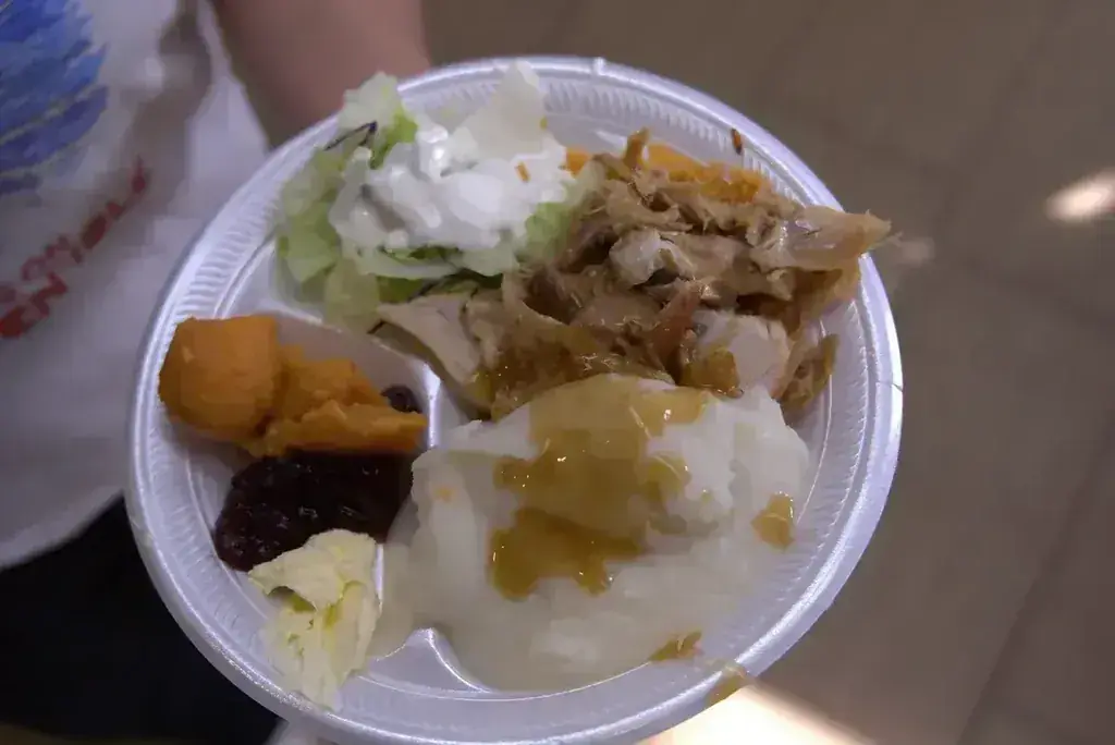 A free Thanksgiving dinner plate with turkey, mashed potatoes, gravy, yams, and cranberry sauce at Harry's Cafe, Katella Ave, Stanton, CA