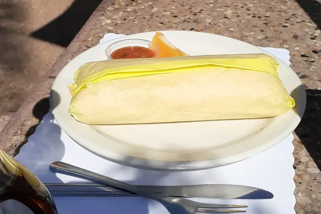 A wrapped breakfast burrito on a plate at Harry’s Cafe, Katella Ave, Stanton, CA.