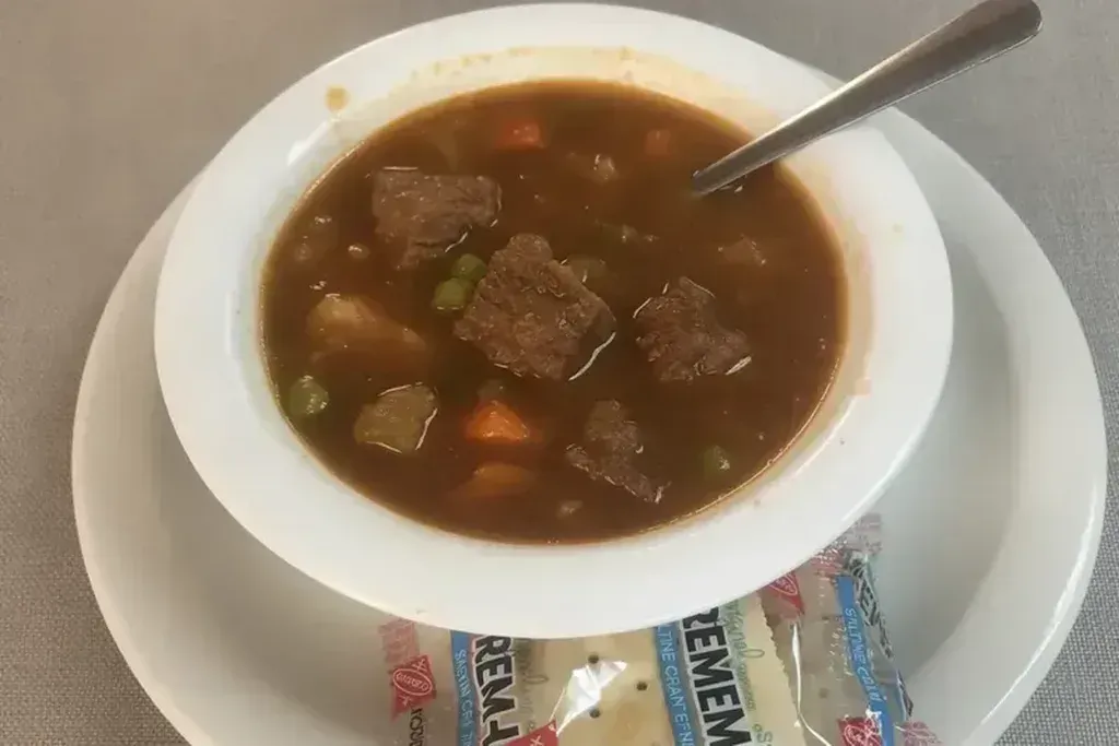 A bowl of vegetable beef soup with crackers at Harry's Cafe, Katella Ave, Stanton, CA