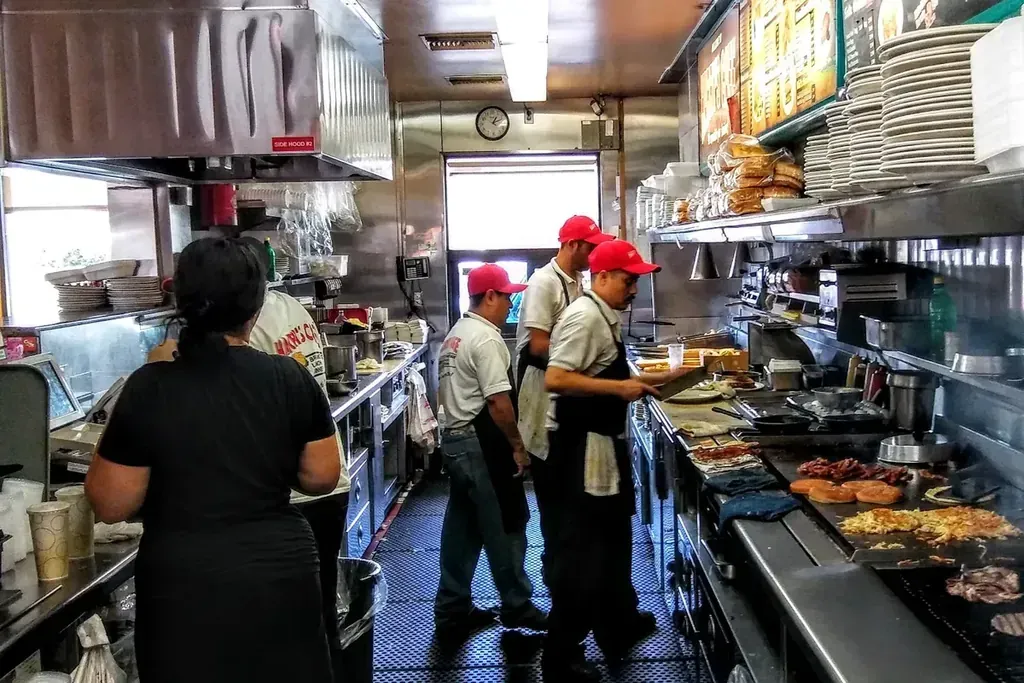 Cooks working the kitchen line at Harry's Cafe, Katella Ave, Stanton, CA