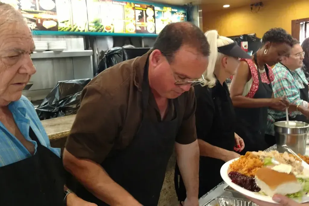 Staff serving plates at the annual Thanksgiving dinner at Harry's Cafe, Katella Ave, Stanton, CA