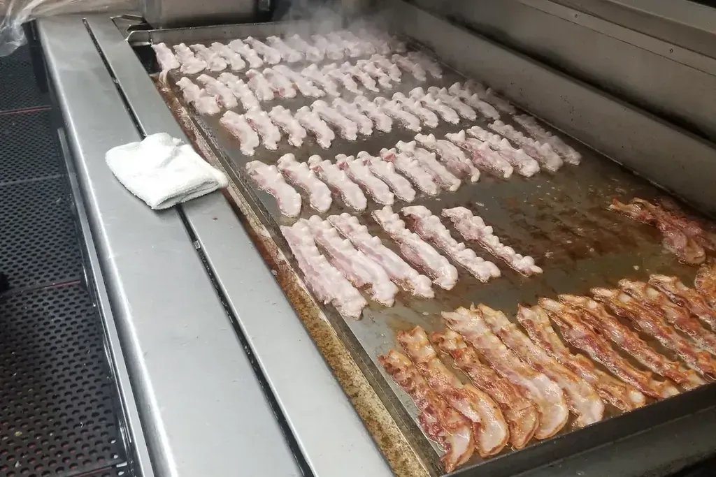 Bacon cooking on the flat-top grill at Harry's Cafe, Katella Ave, Stanton, CA