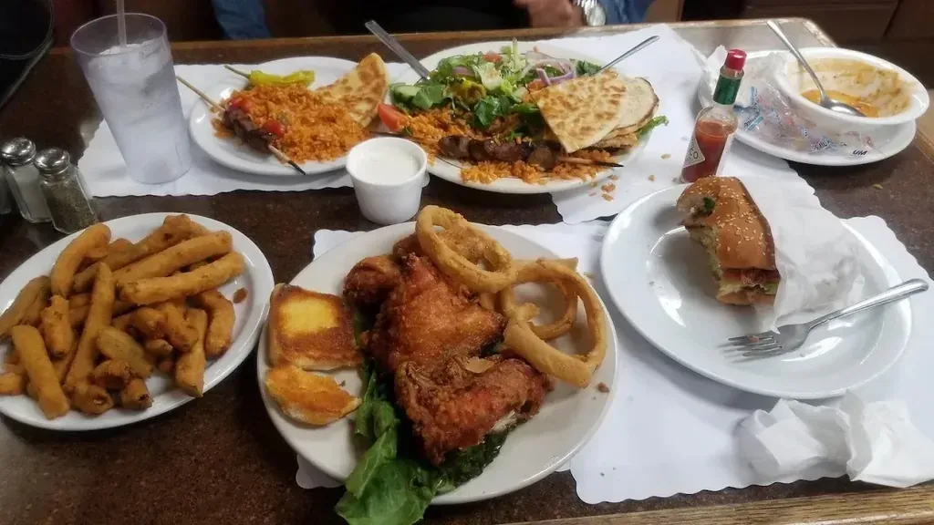 A Greek plate with kebob skewers on pita, rice, and a salad at Harry’s Cafe, Katella Ave, Stanton, CA.