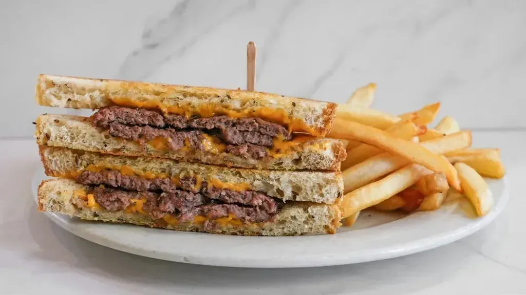 A club sandwich cut in quarters with a drink, combo meal menu at Harry's Cafe restaurant, Katella Ave, Stanton, CA