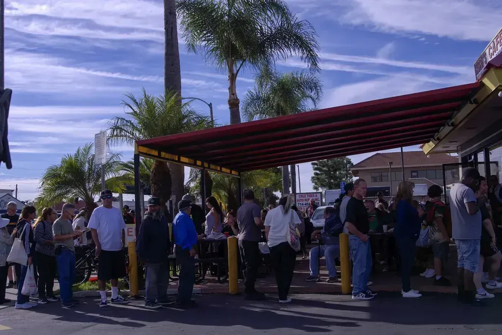 Customers waiting under the red awning at the patio at Harry's Cafe, Katella Ave, Stanton, CA