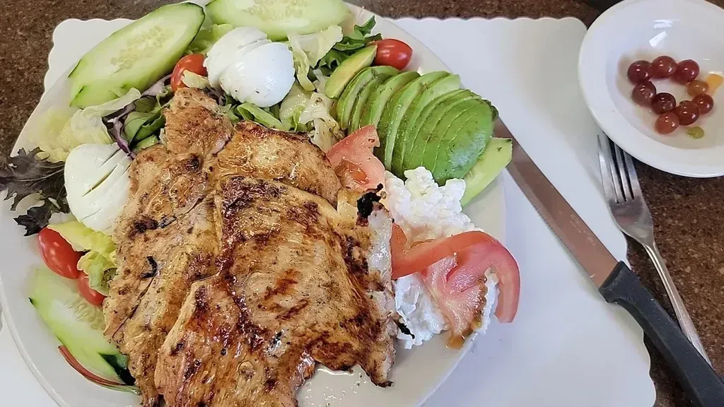 A grilled chicken salad with avocado, tomato, and cottage cheese at Harry's Cafe, Katella Ave, Stanton, CA