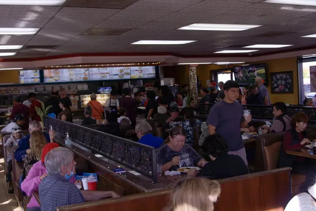 Guests seated in the booths and at the tables of the dining room at Harry’s Cafe, Katella Ave, Stanton, CA.