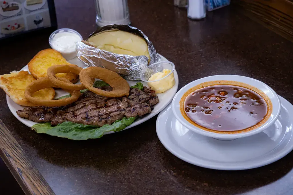 A takeout spread with a shrimp salad, BBQ ribs, and a kebob plate on the dinners menu at Harry's Cafe, Katella Ave, Stanton, CA