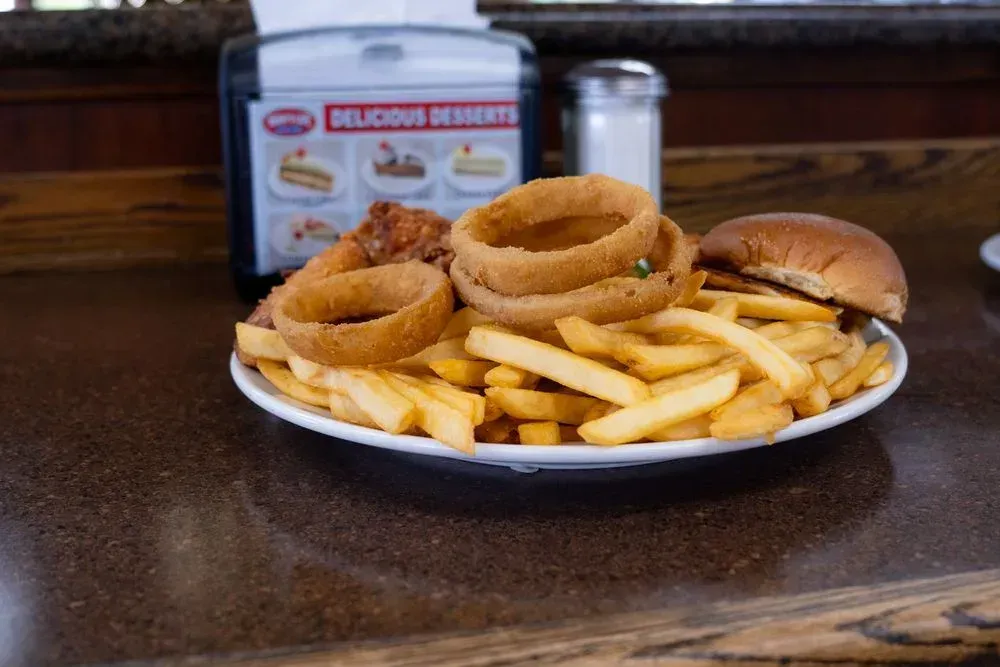 A wrapped cheeseburger with a side of onion rings, a combo meal at Harry's Cafe restaurant, Katella Ave, Stanton, CA