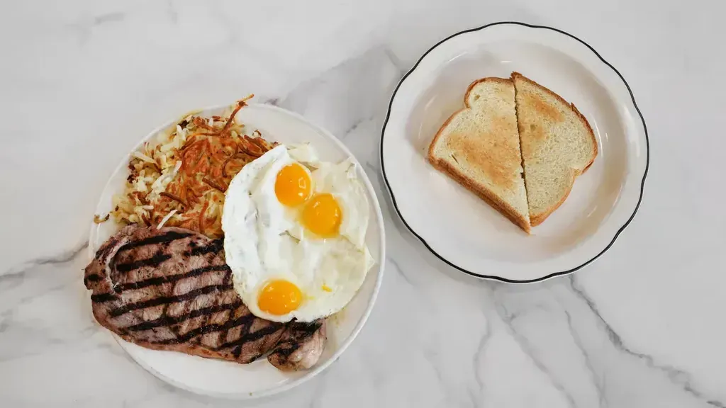 An all-day breakfast plate of steak and eggs with home fries at Harry's Cafe restaurant, Katella Ave, Stanton, CA