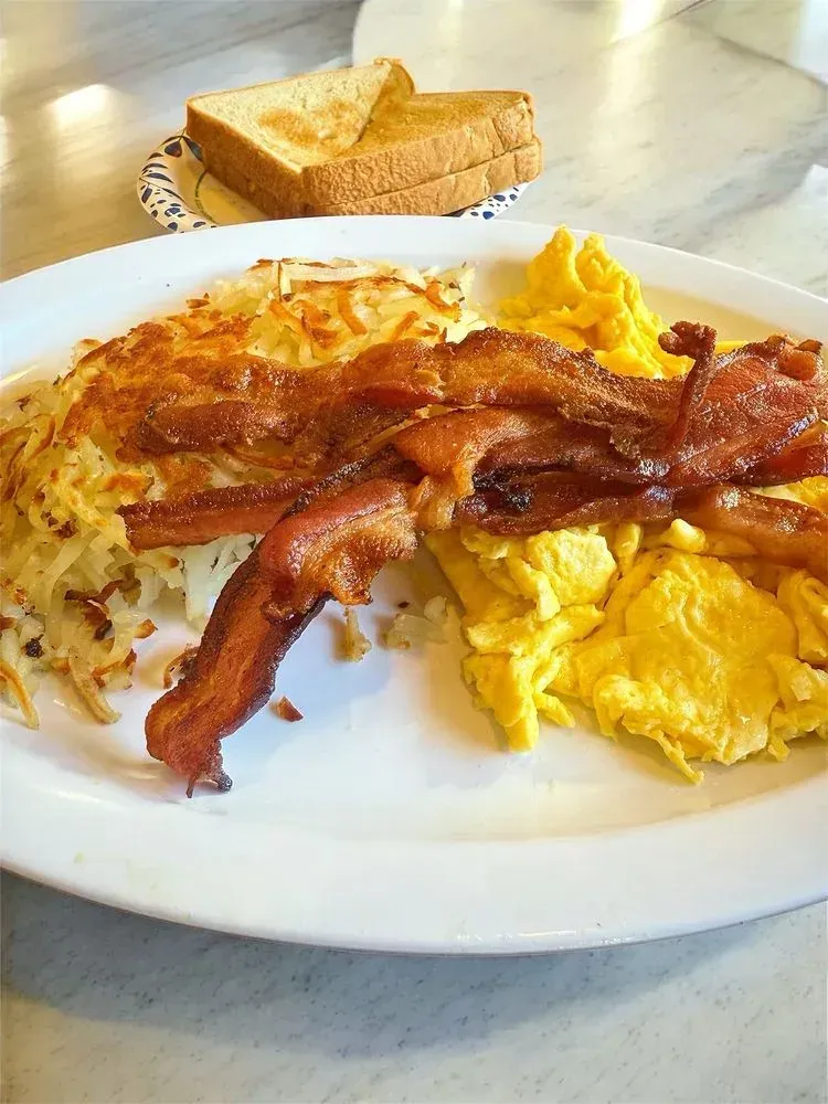 Grilled meat with shredded hash browns and scrambled eggs on a plate at Harry’s Cafe, Katella Ave, Stanton, CA.