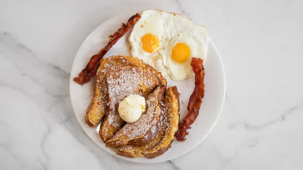 French toast with butter, bacon, and two fried eggs at Harry's Cafe, Katella Ave, Stanton, CA