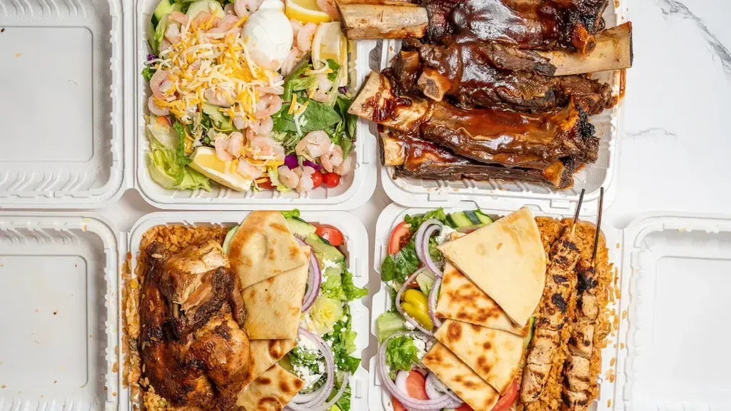 A catering spread of BBQ ribs and a kebob plate with shrimp salad and a chicken gyro from Harry's Cafe restaurant, Katella Ave, Stanton, CA