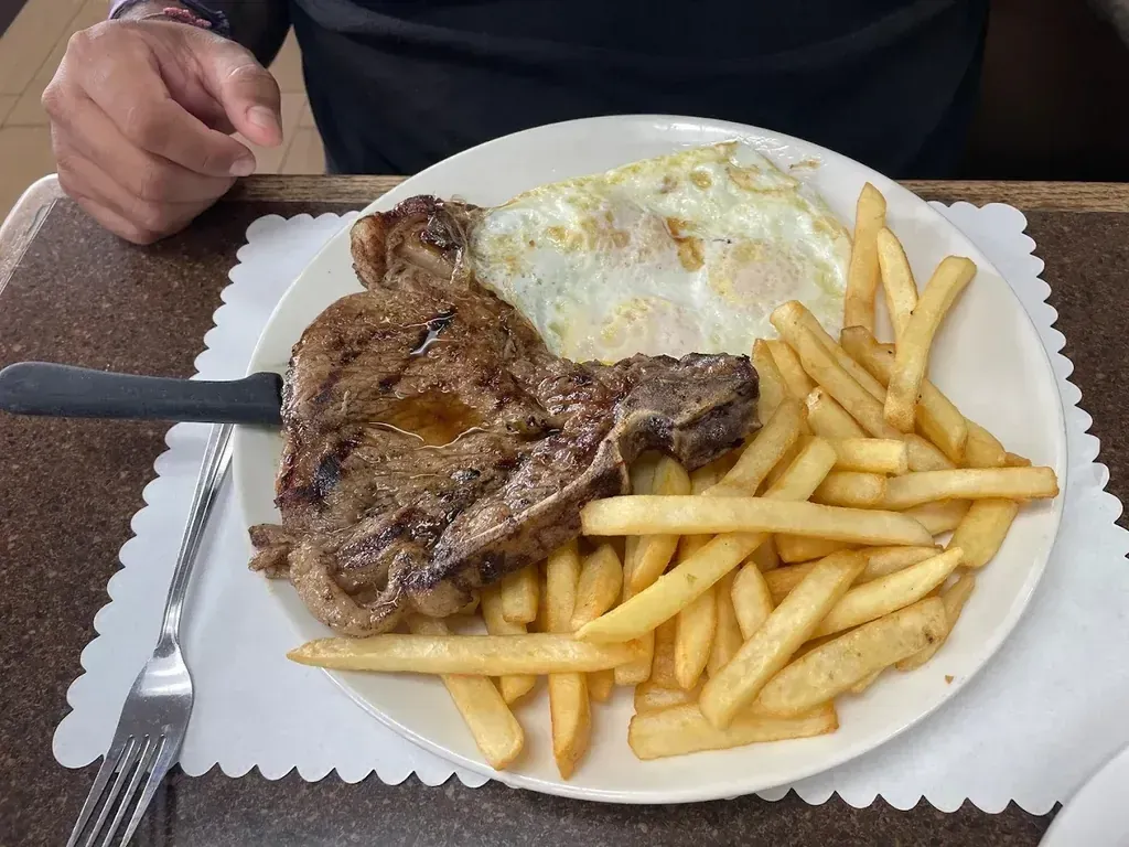 A rib eye steak with fried eggs and french fries at Harry's Cafe, Katella Ave, Stanton, CA
