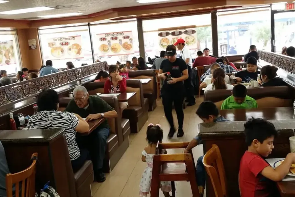 Families filling the booths in the dining room at Harry’s Cafe, Katella Ave, Stanton, CA.